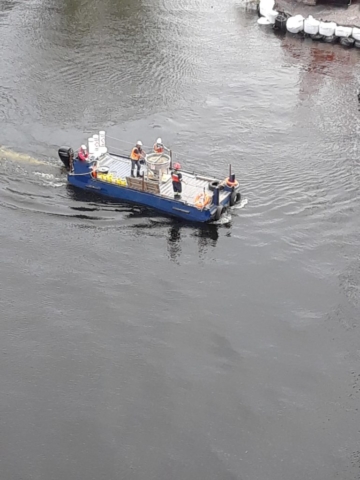 small barge delivering concrete to pump truck