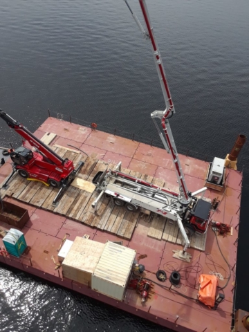 Large barge with concrete pump truck