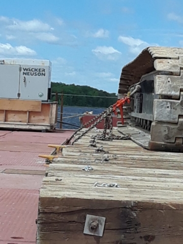 Crane being secured to the barge