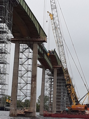 Removed girder being lowered to the barge