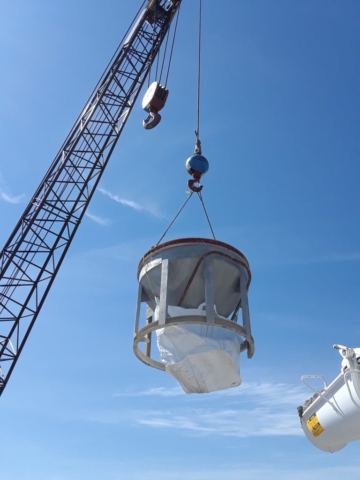 Concrete being lifted to deliver to pier top