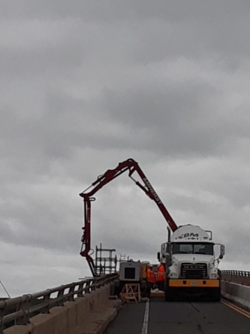 Concrete pump truck pouring concrete for pier refacing