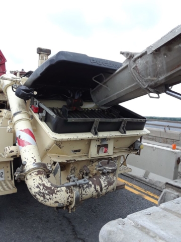 Concrete pump truck being filled with concrete