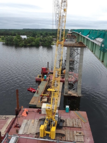 Three barges being used to prepare for girder placement