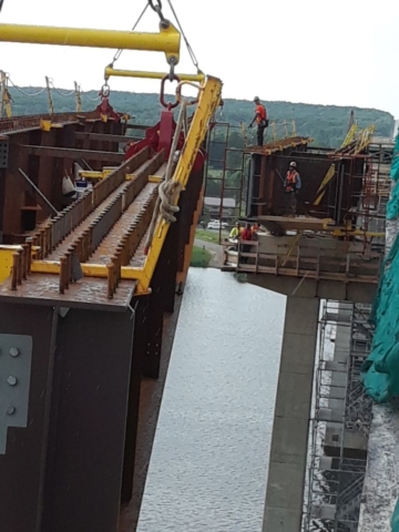 Girder being lowered into place