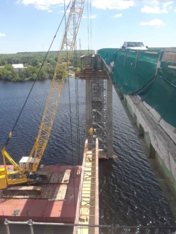 Fourth girder removal lowering on to the barges