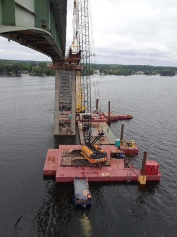 New girder being lifted from barges for placement