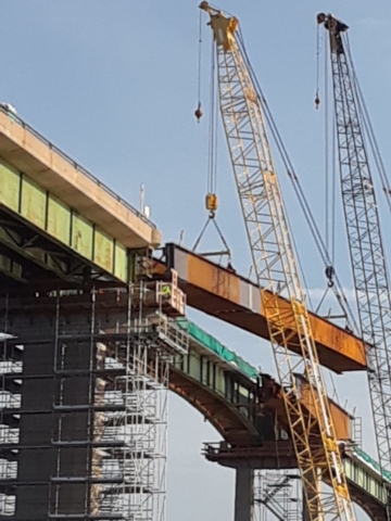 Girder being lowered into place