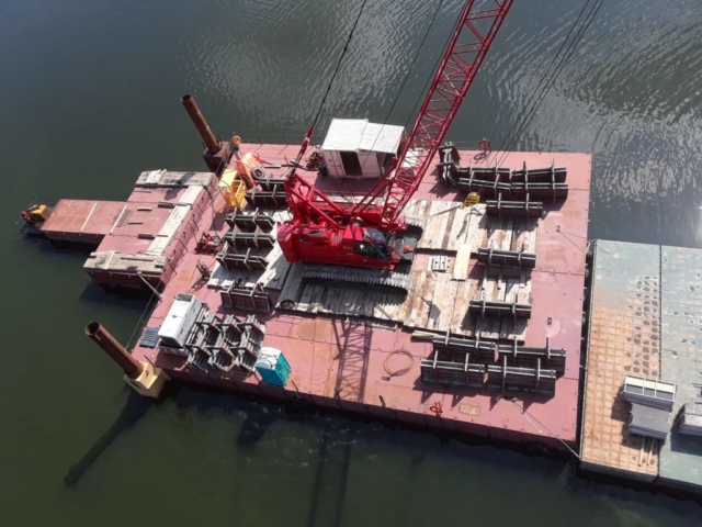 Barrier wall forms on the barge ready to be lifted to the deck