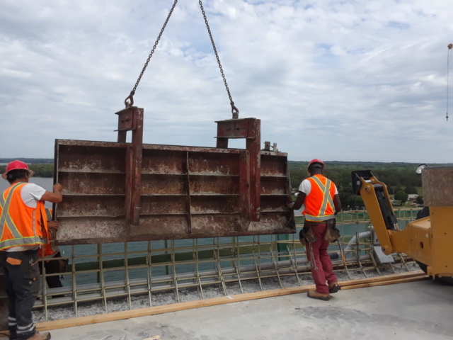 Placing barrier wall form for concrete placement