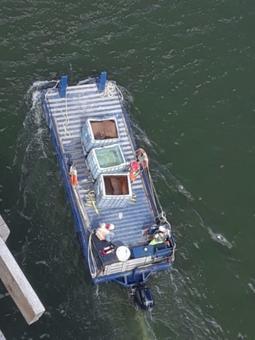 Curing material being delivered to the barge to be lifted to the deck