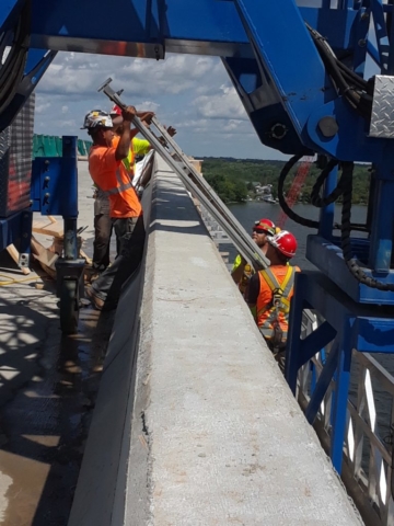 Removal of temporary brackets from deck using hydraulic lift