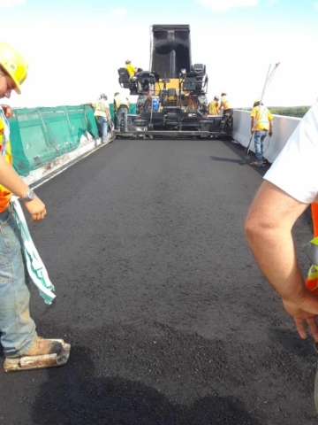 Finishing the first lift of asphalt