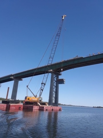 Containment bin being raised to the bridge deck