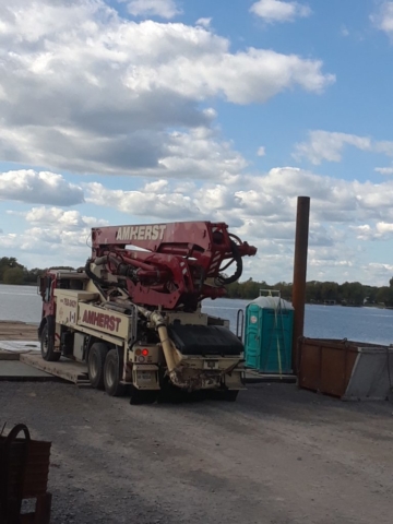 Concrete pump truck being offloaded from the barge