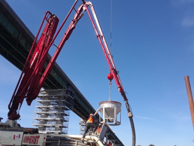 Concrete bucket being lowered to the pump truck