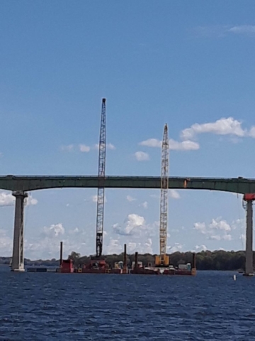 Cranes in place while the girder is being cut for removal