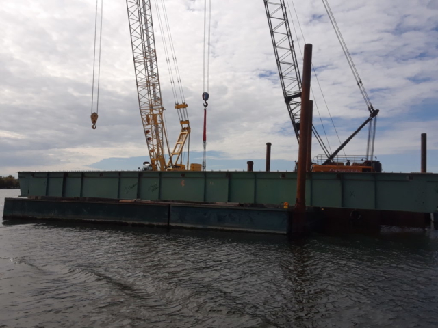 First piece of girder on the barge to be transported to shore