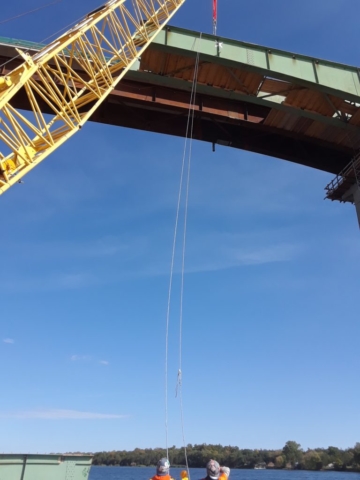 Guide ropes attached to help the third piece of girder to the barge