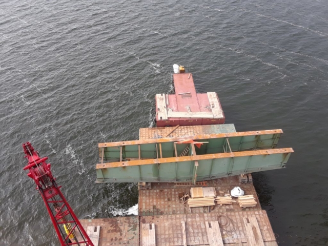 Girder section on the barge waiting to be dismantled