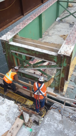 Girder being lowered, view from beside the pier cap