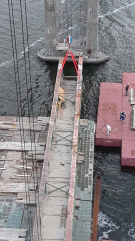 Girder being placed on the barge