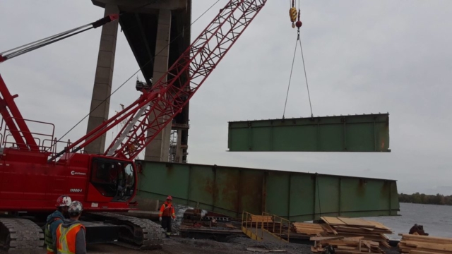 Dismantled section of girder being removed from the barge