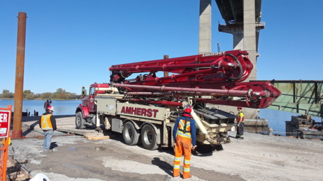 Concrete pump truck being loaded on the barge for concrete placement