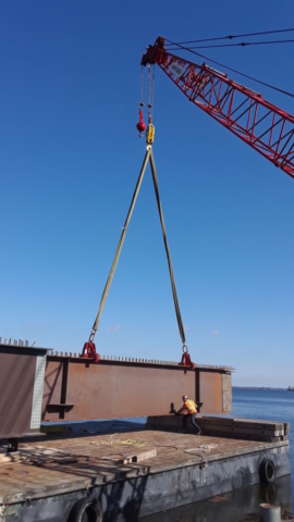 Placing girder section on to the barge for assembly