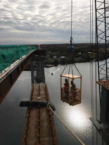 Man cage being raised from the barge to complete tasks for the new girders