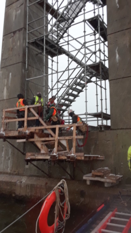 Iron workers heading up the scaffolding for the girder lift