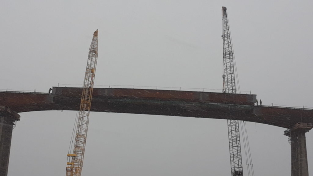 Girder being lowered into place