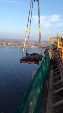 Burlap curing material being lifted from the barge