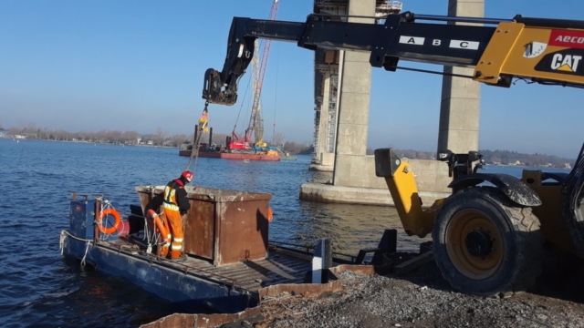 Container of concrete slurry being removed from the boat