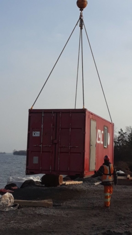 "C" can container being removed from the dock