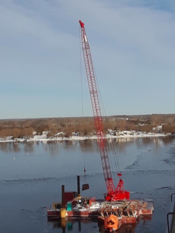 Barrier wall form being lifted to the deck