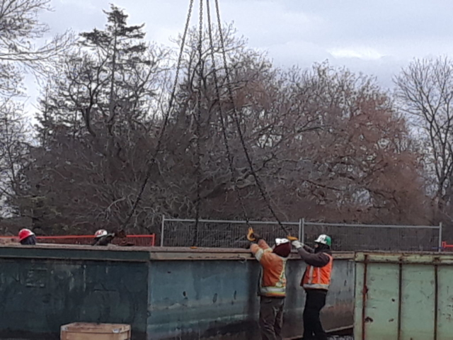 Connecting the crane, to lift the barge piece into place for winter storage