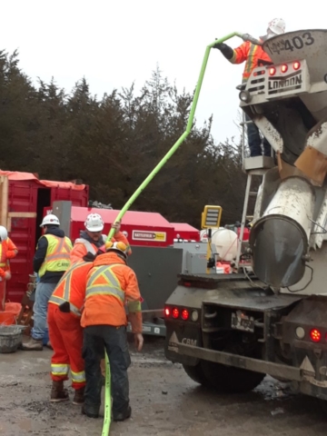 Water being added to high strength concrete for the closure strip