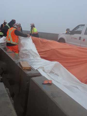 Covering the fresh concrete with plastic and tarps