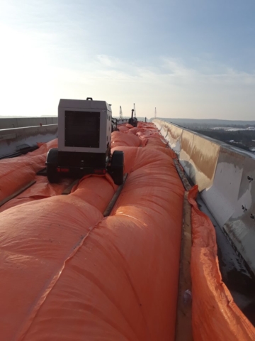 Frost heaters and tarps heating the concrete deck