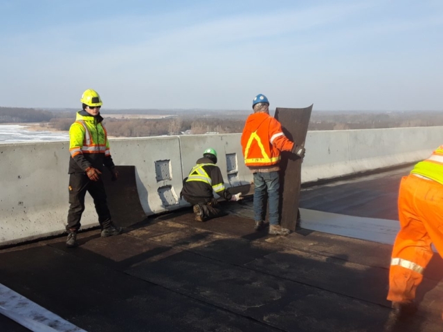 Protection board being placed over waterproofing membrane