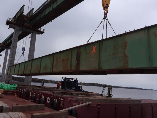 Girder section being lowered onto the barge