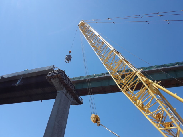 Hopper being raised for pier top concrete placement