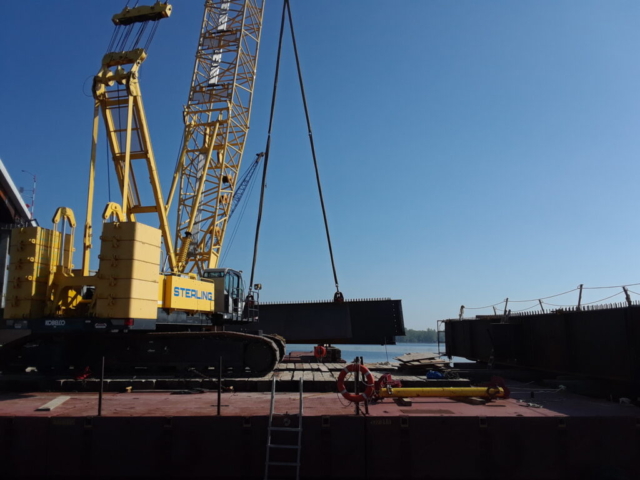 Approach girder being lowered onto the barge