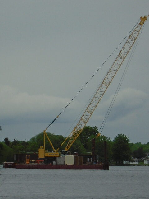 Barge with the final girder section moved out to the piers before placement