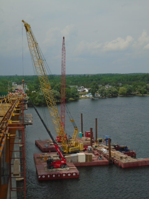 Both cranes lifting materials to the deck for form-work installation / Magni lift fr installation of support brackets