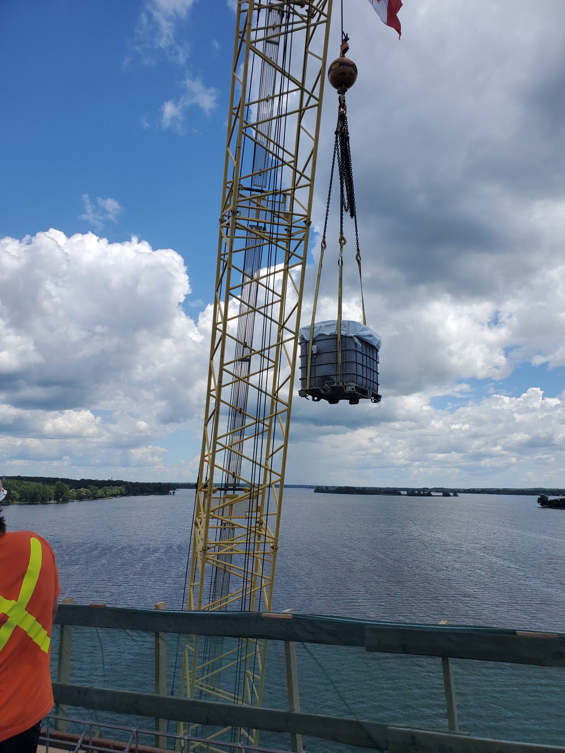 Container of water and burlap being lifted from the barge