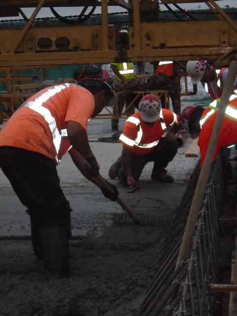 Troweling and spreading newly placed concrete