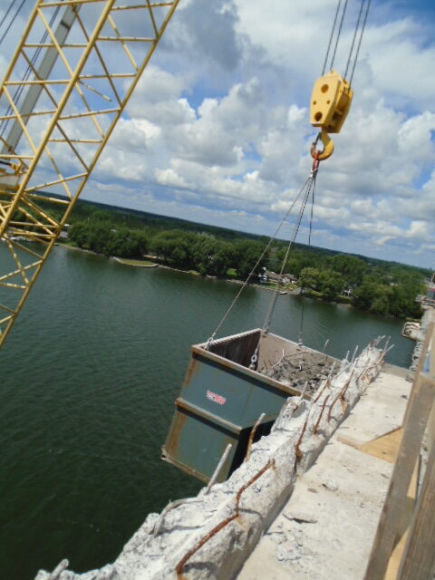 Containment bin for concrete rubble being lifted to the deck by the crane on the barge