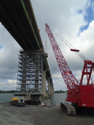 110 ton crane lifting the bin for dismantled scaffolding